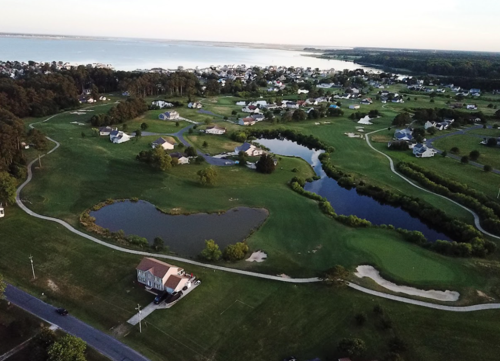 aerial view of golf course, neighborhood, and Chincoteague Bay